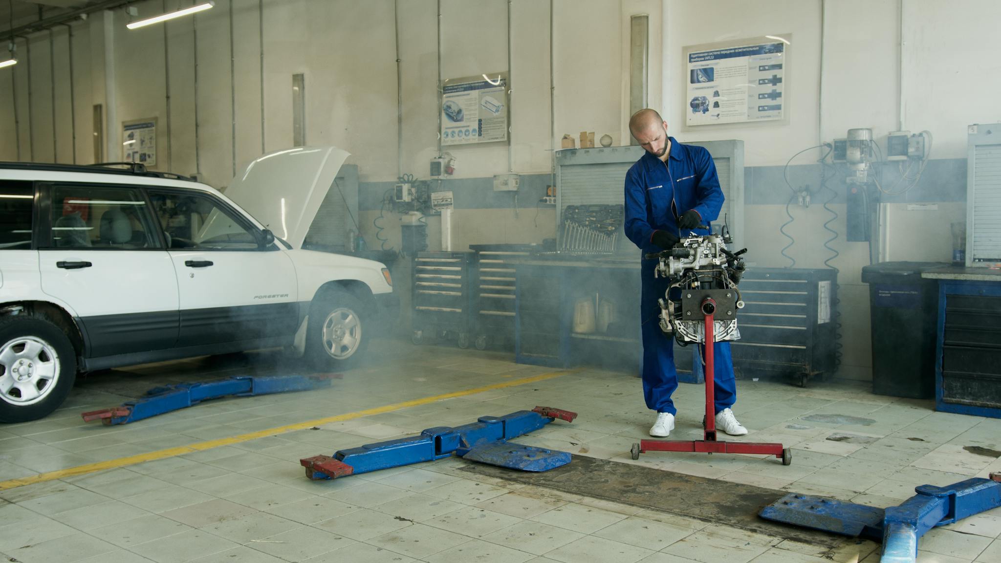 mechanic in blue overalls working on a