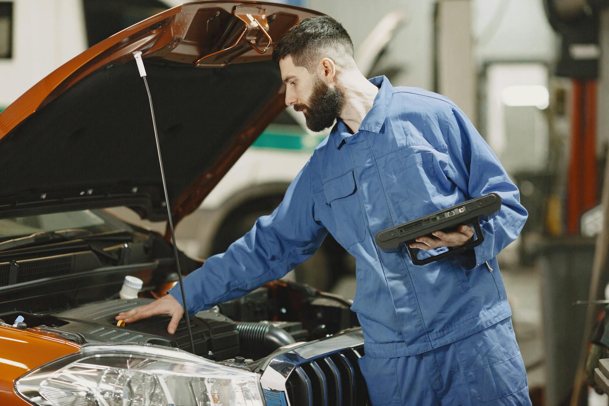 professional mechanic examining a car engine under
